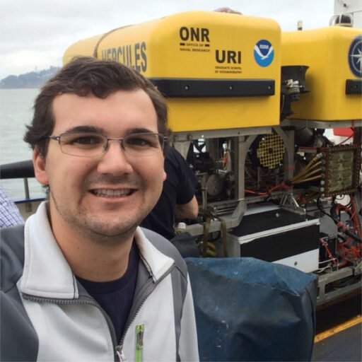 Headshot of Brian Grau with an ROV in the background